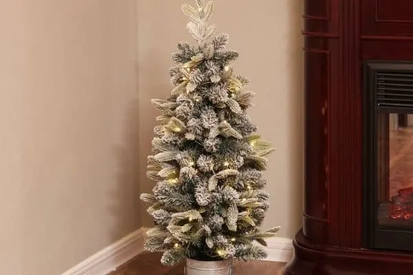 A 3.5 foot flocked Christmas Tree with a galvanized bucket base.