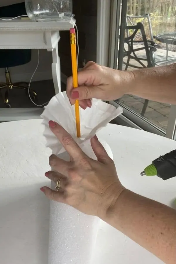 Adding the first filter to the foam by putting the pencil in the center.