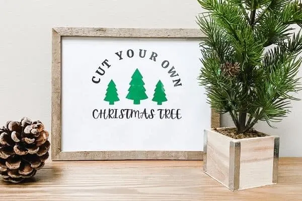 a farmhouse Christmas printable that says cut your own Christmas Tree and has 3 pine trees on it.