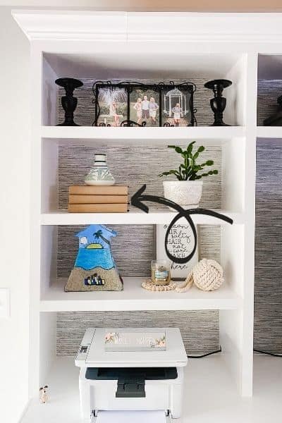 This is a close up of how to use books to prop up another decor item.