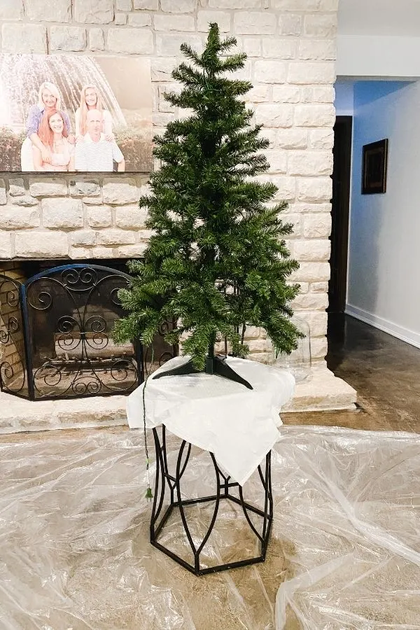 A 3 foot tree before being flocked with a plastic drop cloth under.