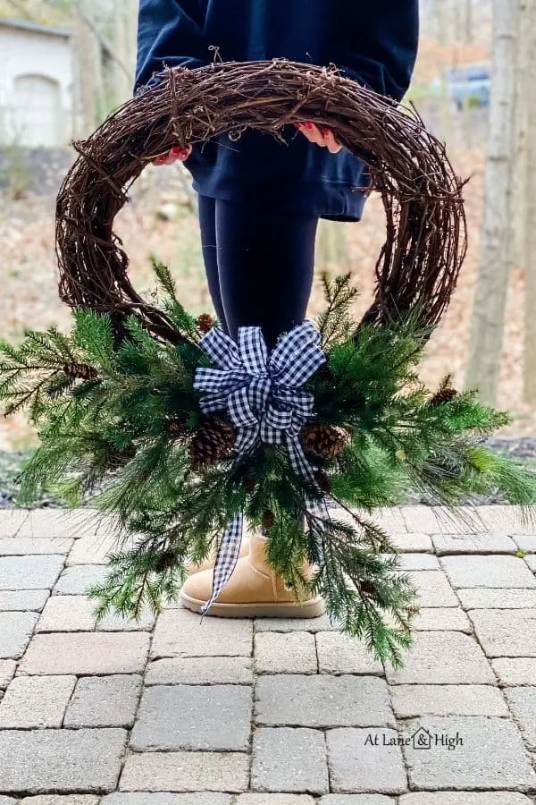 The finished wreath with the buffalo check bow added.