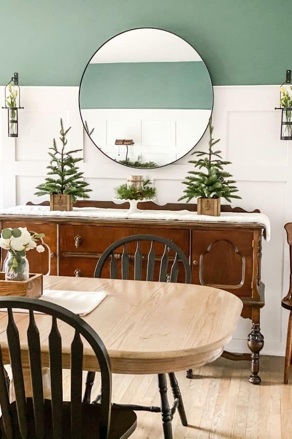 DIY Board and Batten in the dining room decorated with pine trees and white.