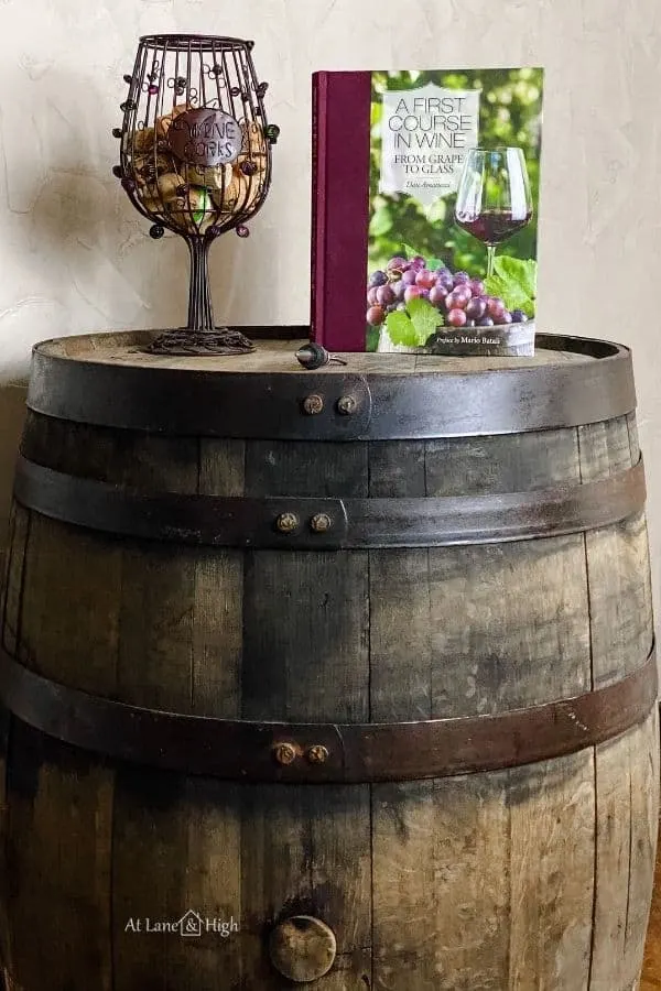 This shows a wine book and a decorative holder for wine corks in the shape of a wine glass on the barrell.