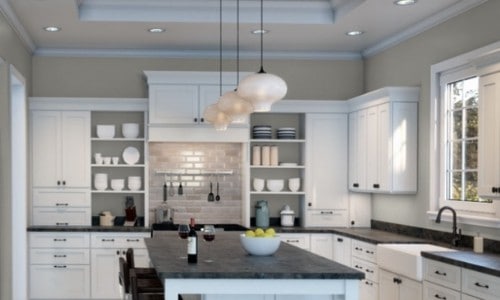 A kitchen painted with Repose Gray and white cabinets and black countertops.