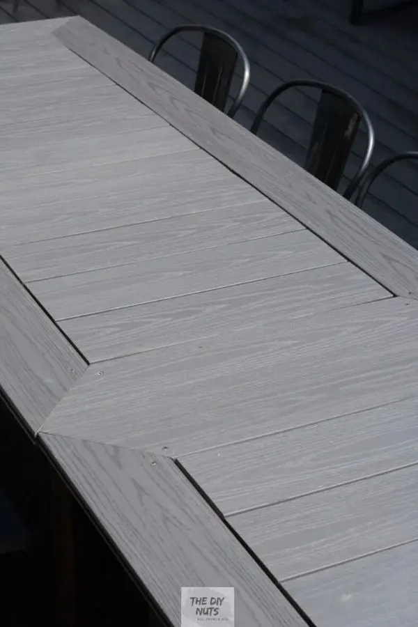 A patio table made using light gray composite decking.
