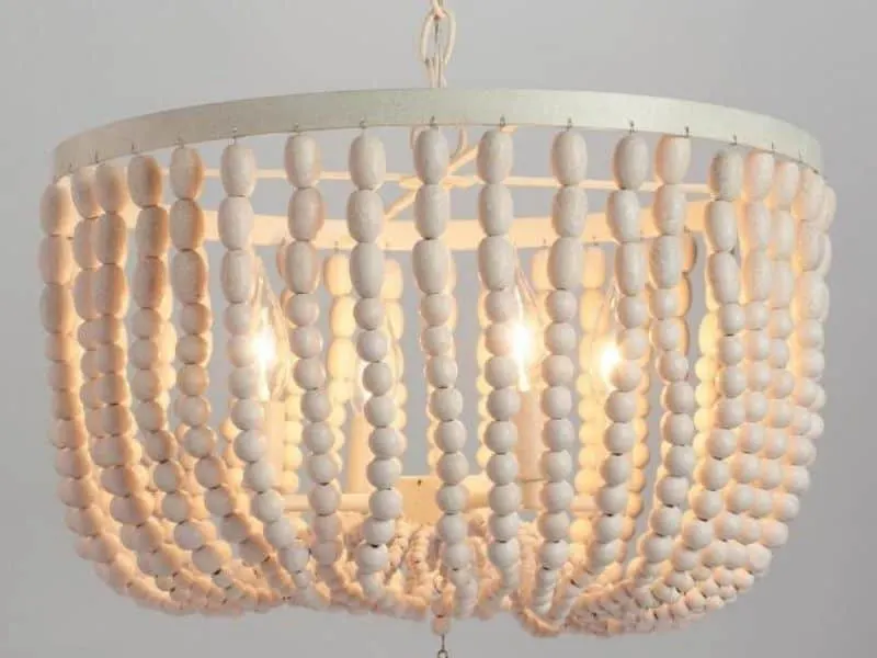 A smaller light fixture with white beads.