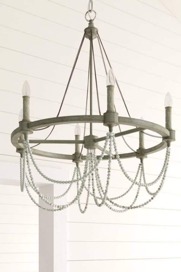 A gray chandelier with beads hanging below the lights.