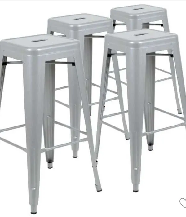 Gray metal bar stools that can be stacked on one another.