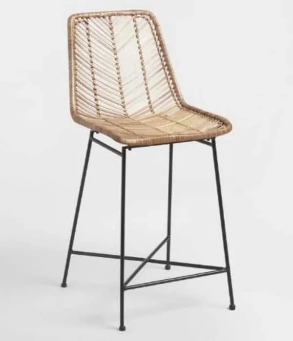 This is a woven rattan bar stool in light beige with a black metal base.