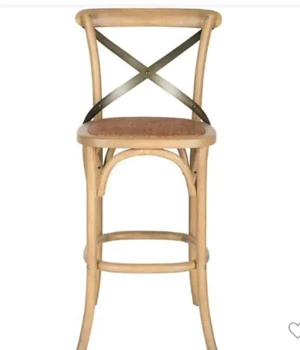 This wooden stool has a metal X detail on the back and a rattan seat.
