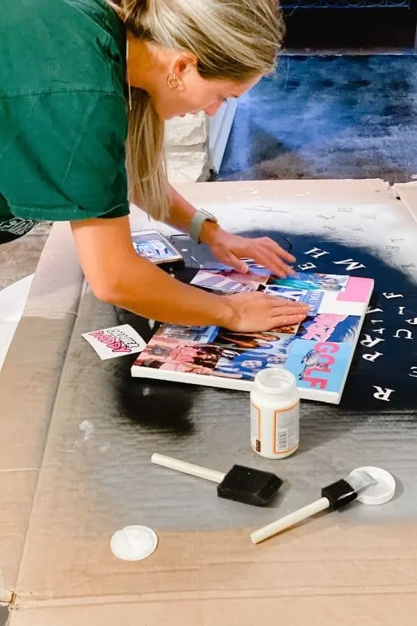 Here my daughter is putting the photos on the canvas after the first coat of mod podge.