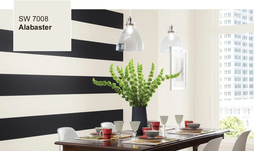 Sherwin Williams Alabaster in a dining room with black and white striped walls and a dark wood dining table.