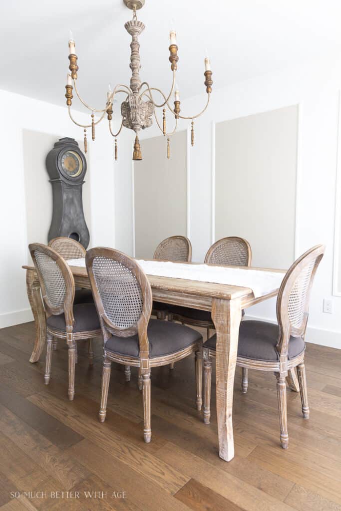 This dining room has picture frame molding on the walls with inside the frames painted Edgecomb Gray and outside all white.