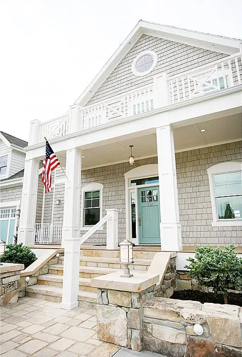 Benjamin Moore Edgecomb Gray on the cedar shake of the exterior of a home and a teal painted front door.