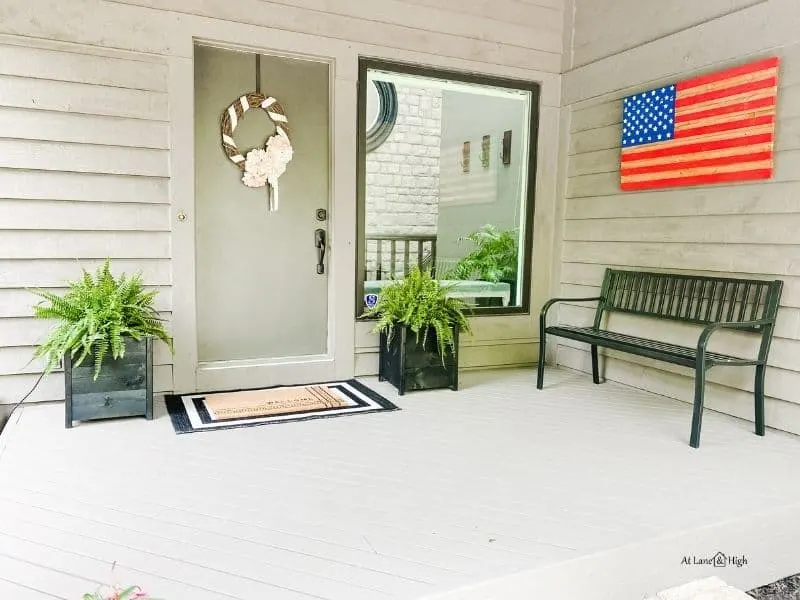 The summer front porch with the added black metal bench.