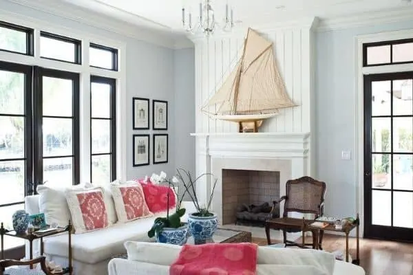 Benjamin Moore Wickham Gray on the walls in a coastal inspired family room with a fireplace that has vertical shiplap above and a large sail boat on the mantel.
