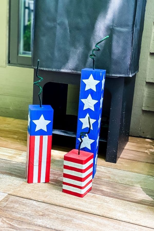 The diy wood firecrackers in front of my husband's smoker.