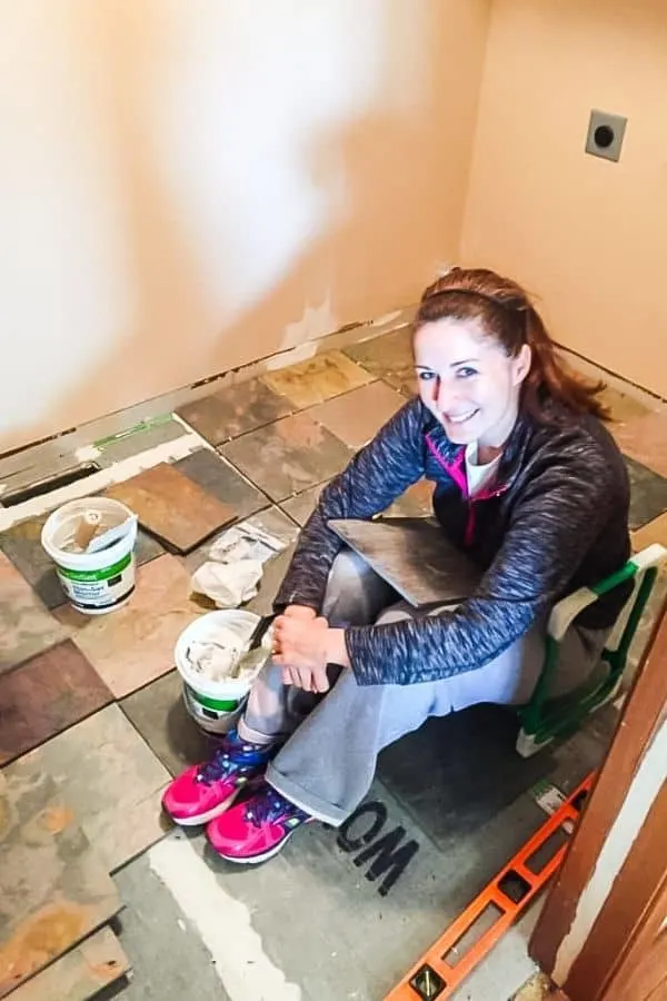Here I am sitting on the floor in the middle of installing a tile with the room about a third done.