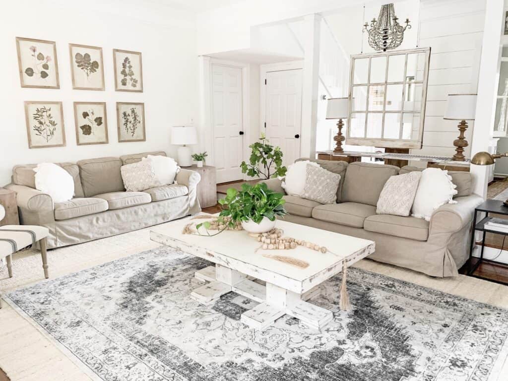 This family room has Alabaster on the walls, gray furniture and white throw pillows.