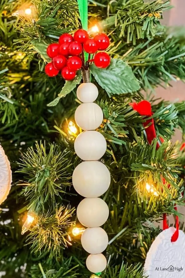 A close up of the wood bead ornaments with the berries.