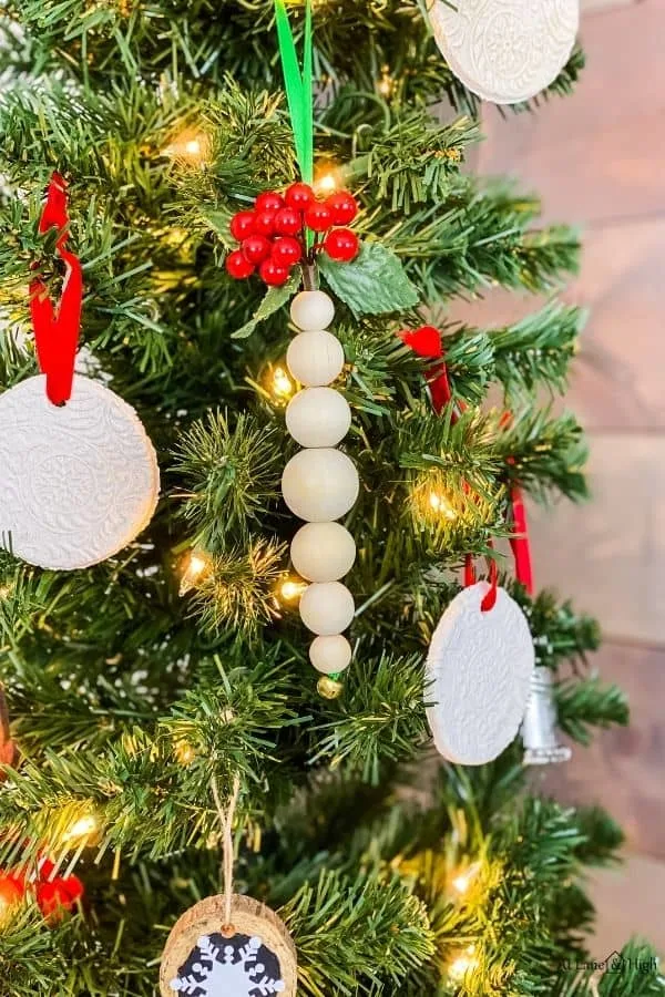The wood bead ornaments hanging on the christmas tree.