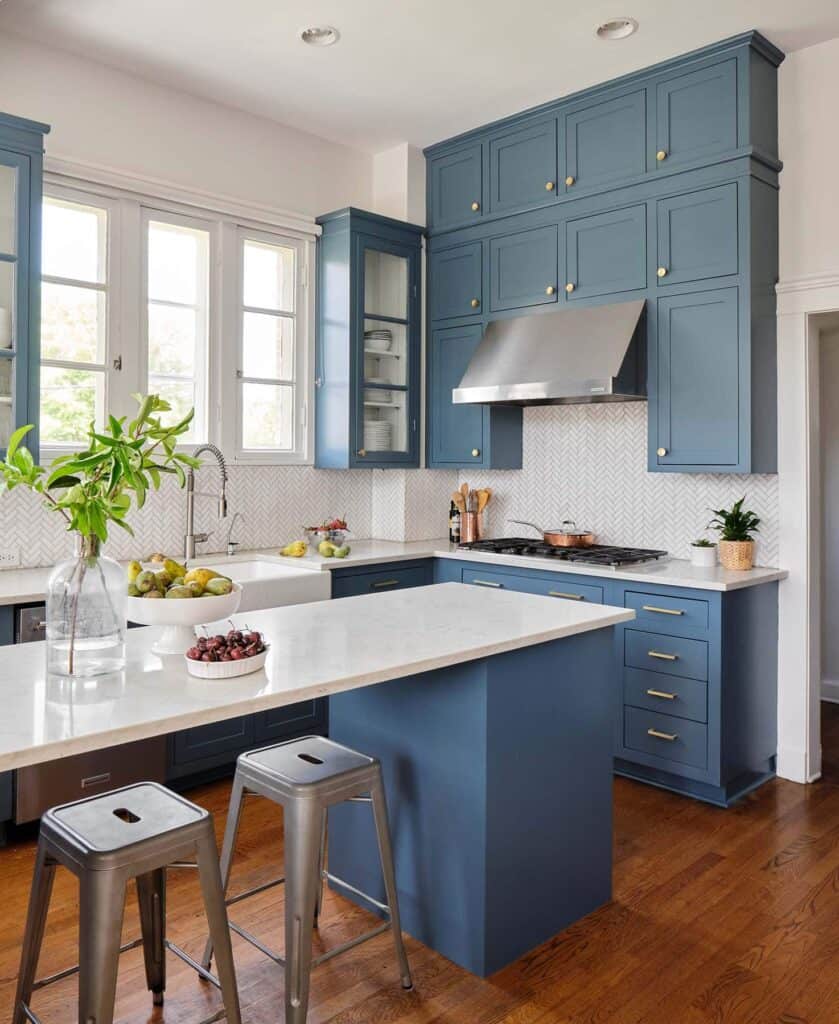 Stillwater is used on kitchen cabinetry with gold hardware and white countertops.