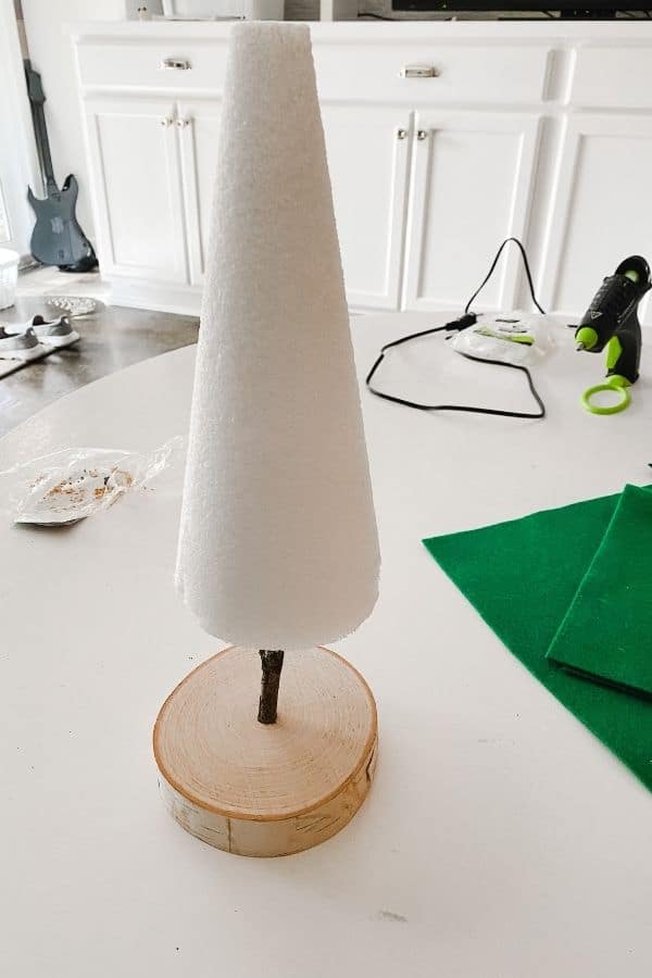 the base with the stick inserted and the foam cone on the top of it.