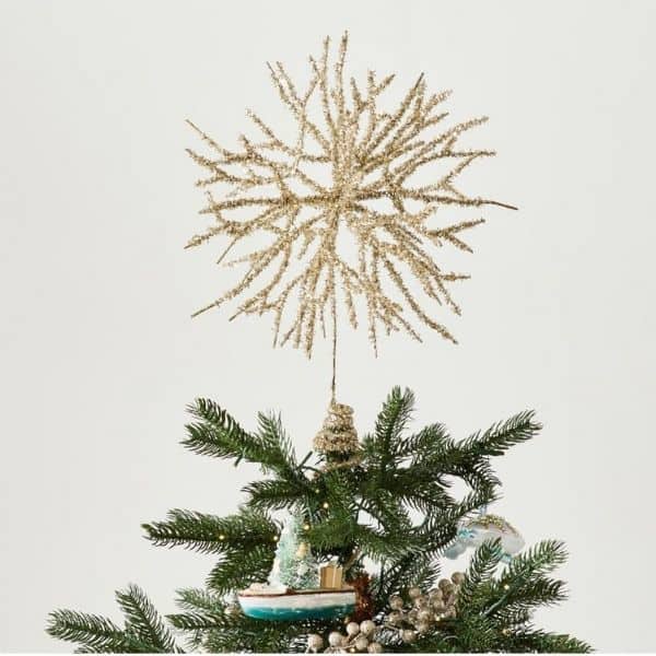 This tree topper is shaped like coral and gold with glitter.