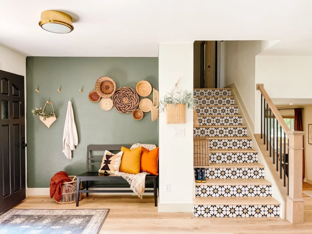 An entryway with a staircase that has a starburst patten on the stair risers.
