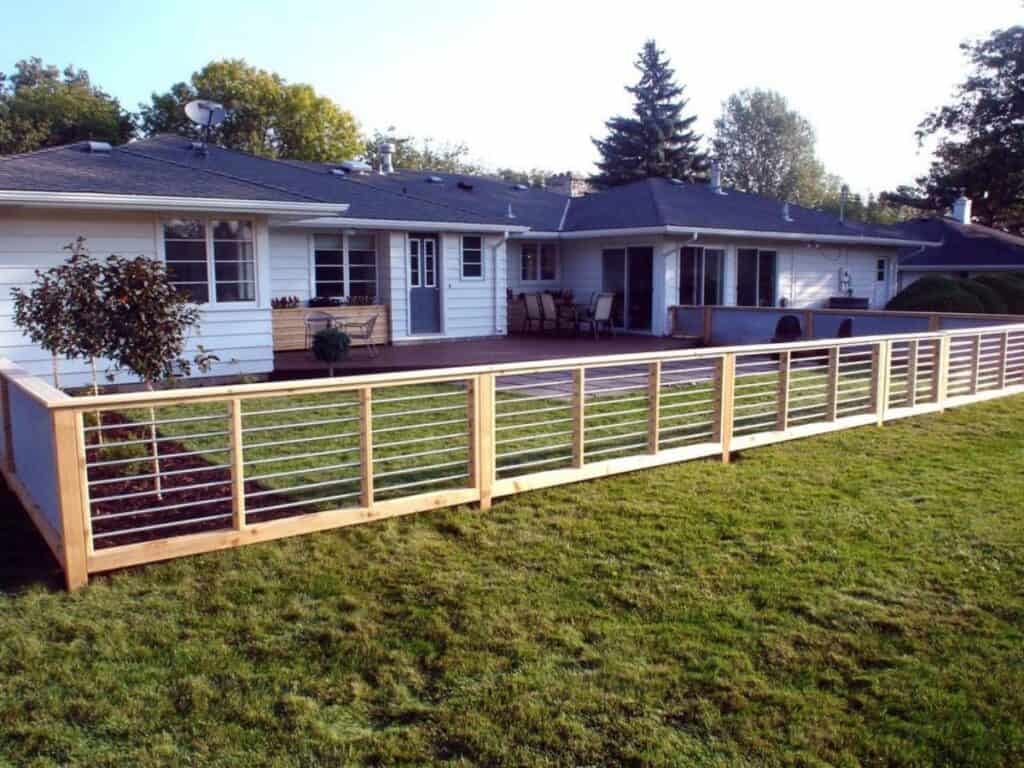 A horizontal fence with pvc pipes allowing lots of light and air to come through.
