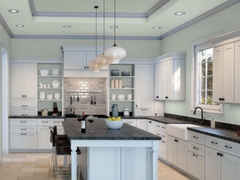 A kitchen with Sherwin Williams Sea Salt on the walls and white cabinets, black countertops and black hardware.