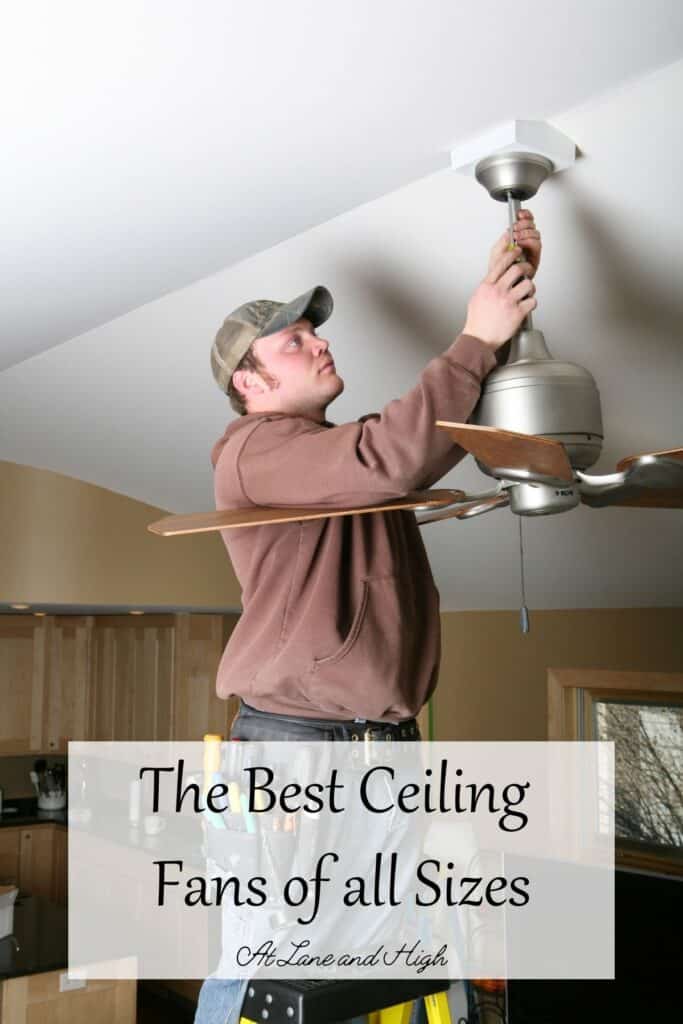 A man is installing a silver ceiling fan with wood toned blades with text overlay.