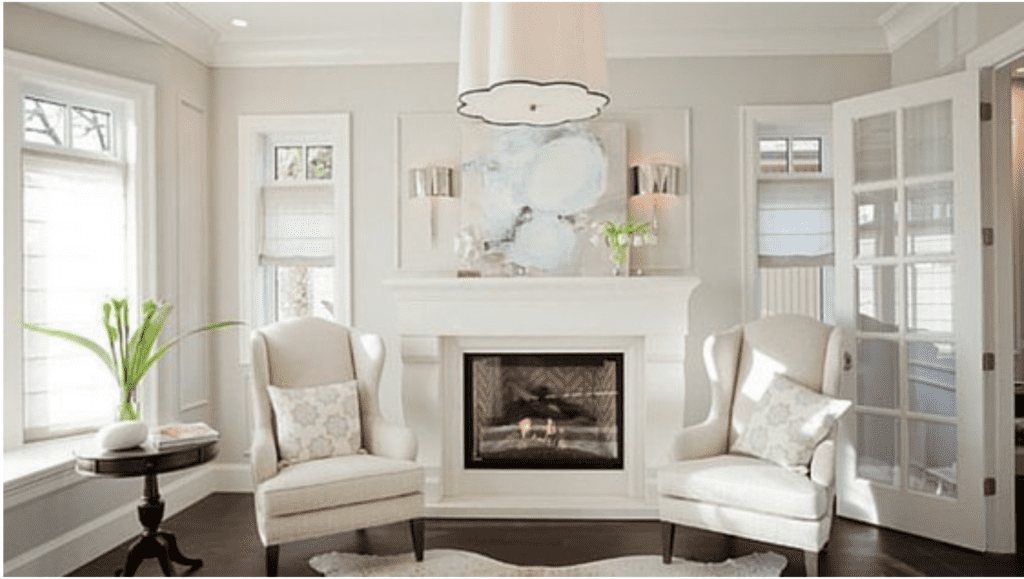 A family room with cloud white on the walls and neutral furniture, dark hardwood floors.