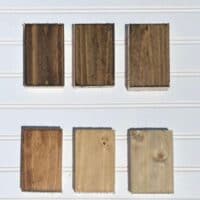 six examples of stain on pine with a white beadboard background.