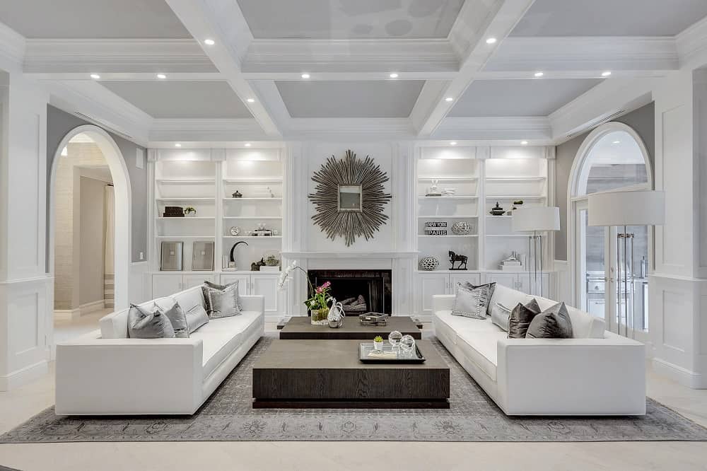 A monochromatic white room with touches of silver in the ceiling panels.