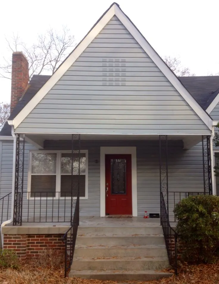 network Gray on the exterior siding, concrete front steps and a red door with white trim.