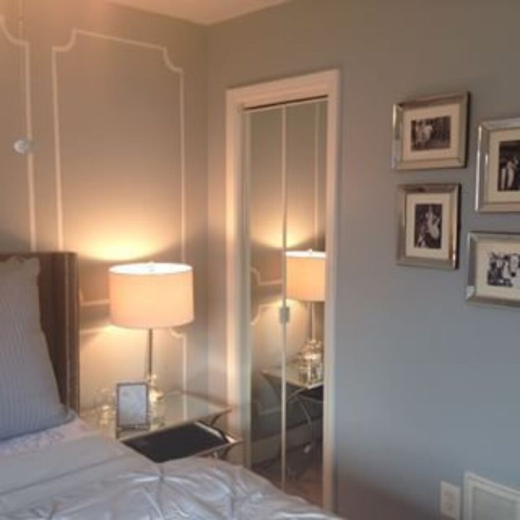 A bedroom with Network Gray on the walls and white picture molding trim!