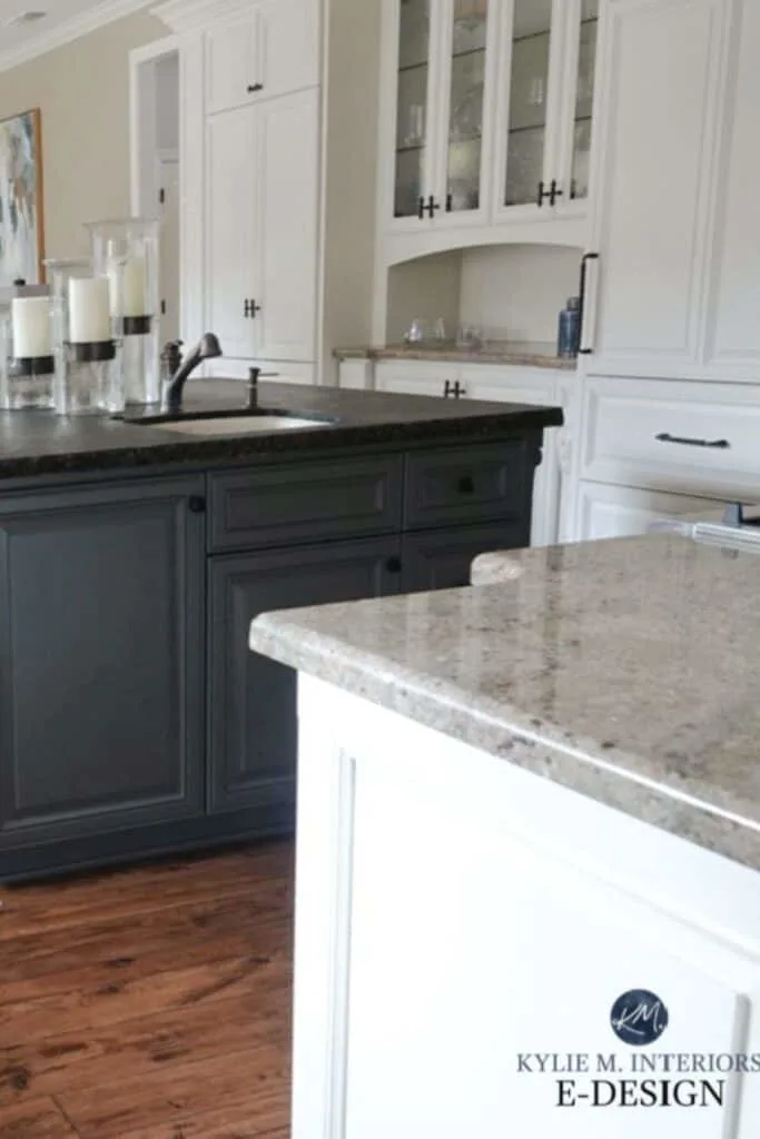 A kitchen with the island painted grizzle gray, dark hardwood floors and the rest of the cabinets in white.