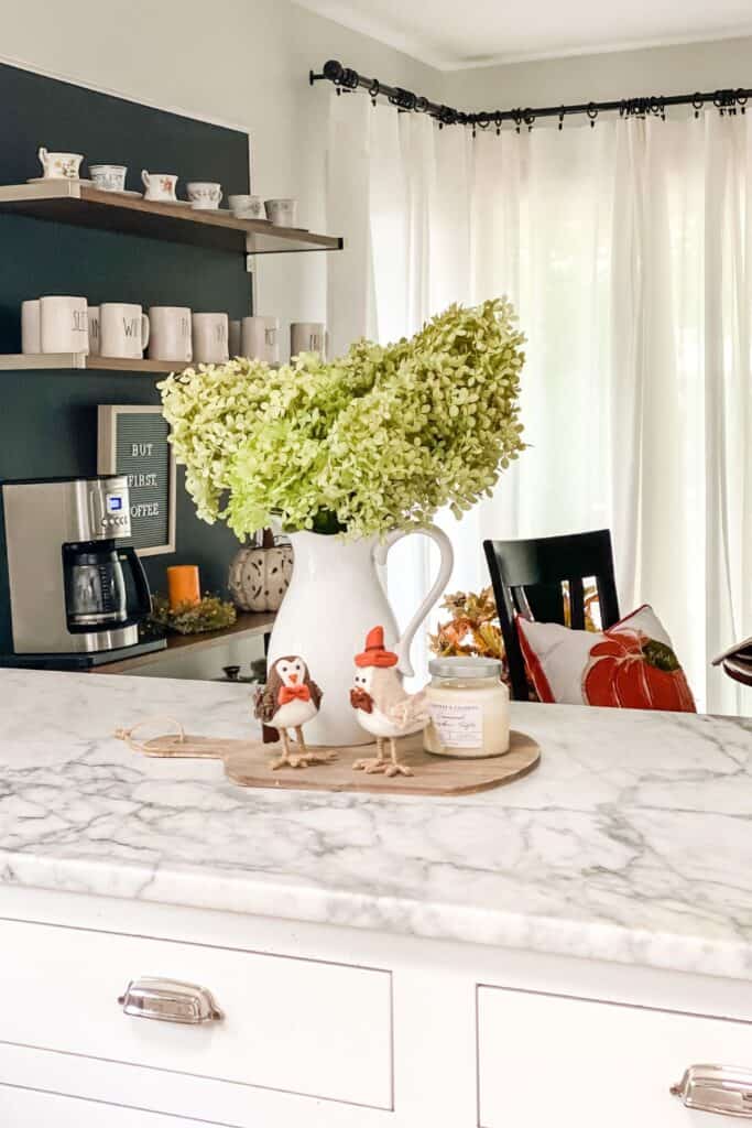 A fall vignette on my marble counters and a view of the breakfast nook behind.