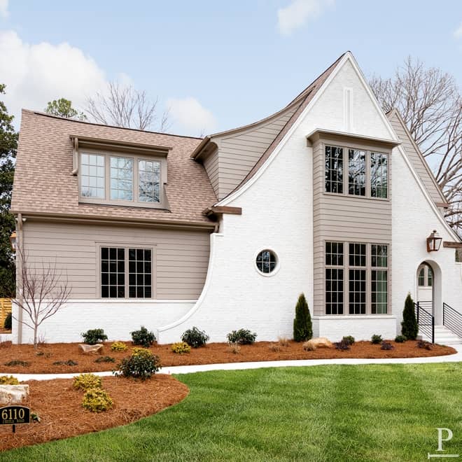 A tudor style home with off white on the stucco and Balanced Beige on the siding.
