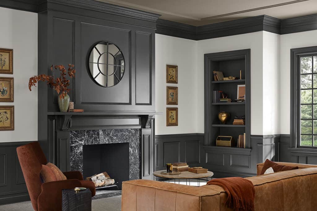 A family room with white walls and Iron Ore on molding above the fireplace, the wainscoting and the trim.
