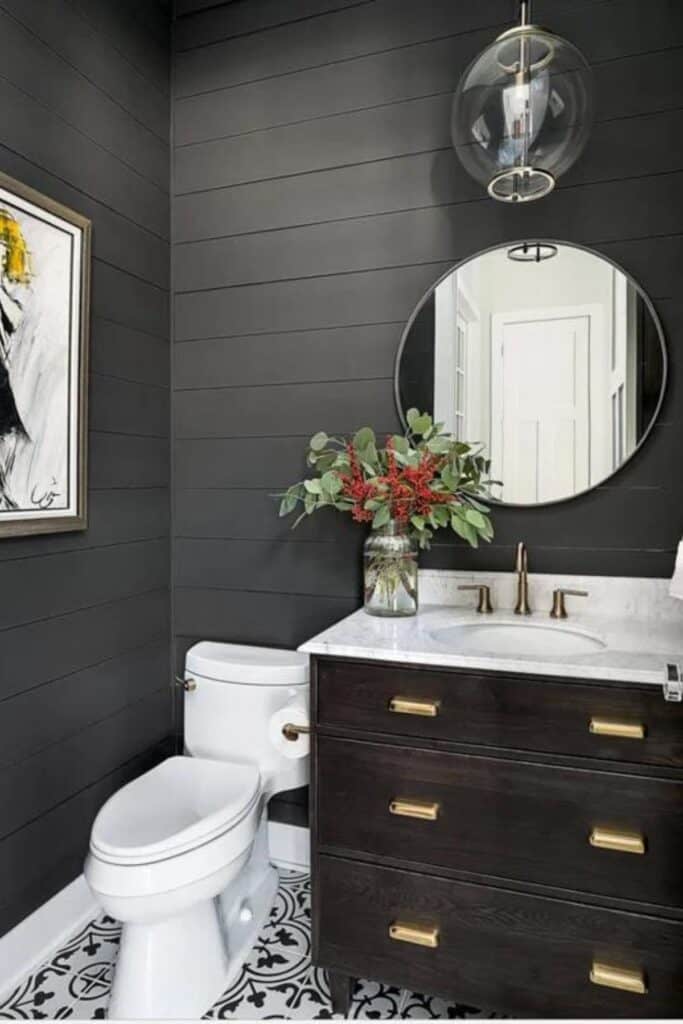 A bathroom with shiplap walls painted Iron re.