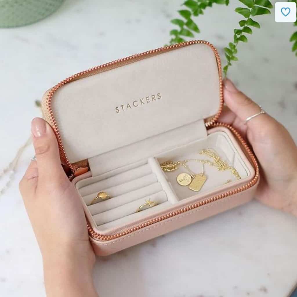 A jewelry box that zips closed and has stacking compartments.
