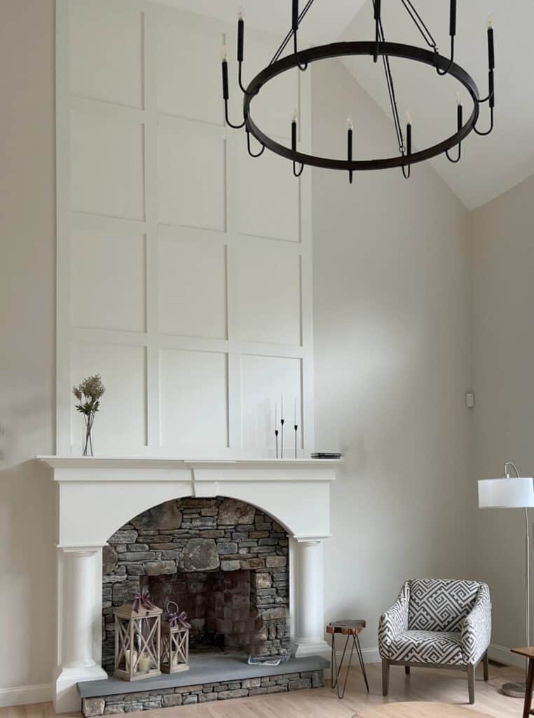 Sherwin Williams White Duck on the millwork of a fireplace with darker walls, and stone on the inside of the fireplace.