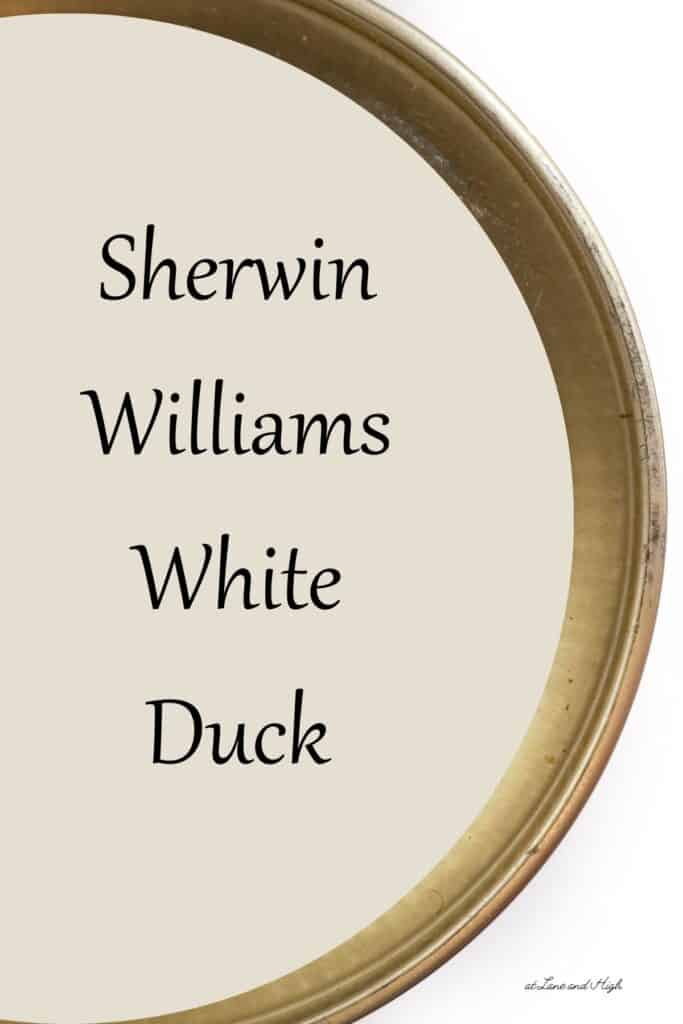 A swatch of Sherwin Williams White Duck from the view of the top of a paint can with text overlay.