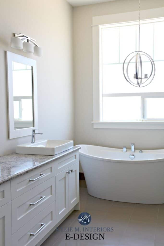 A bathroom with a white free standing tub, white vanity and Aesthetic White on the walls.