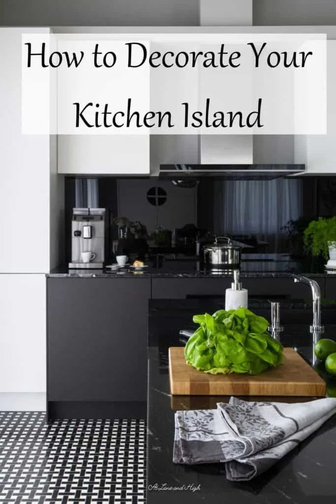 A black and white kitchen with a wood cutting board on the island with veggies ready to be cut.