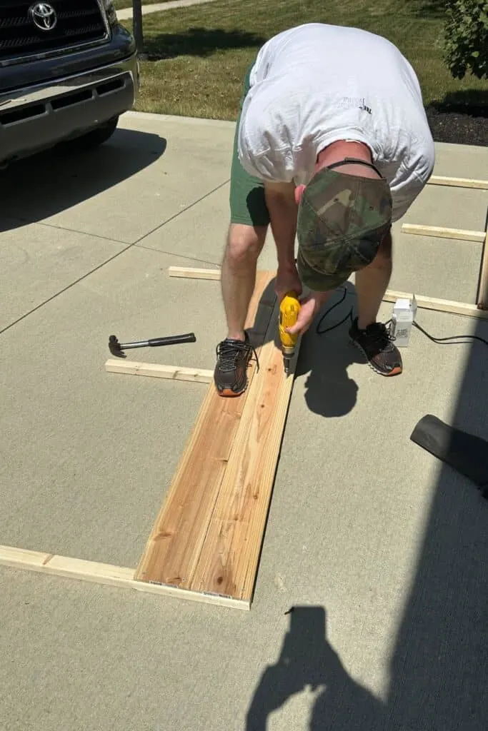 My husband screwing together the sides of the raised garden bed.