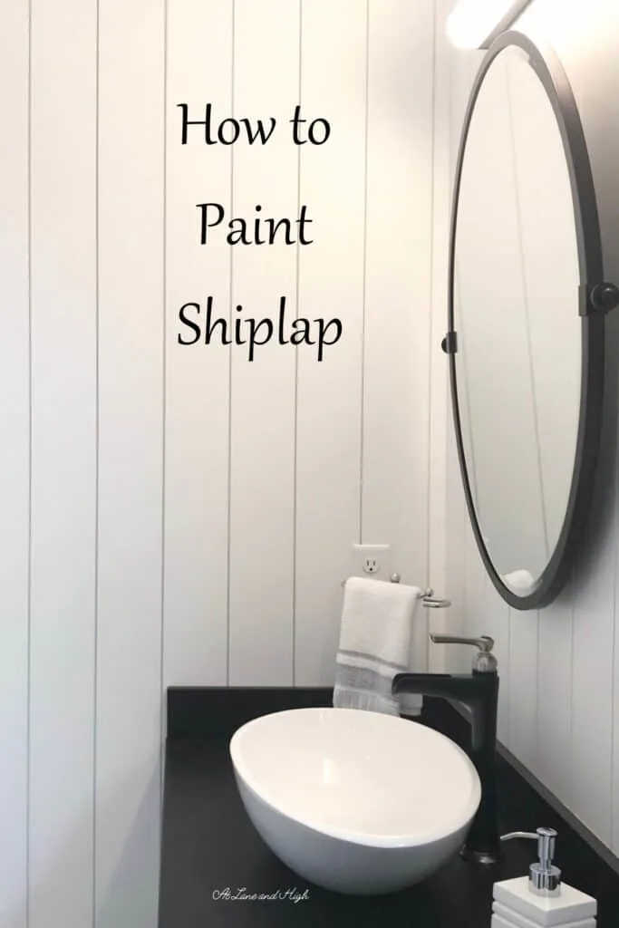 A vertical shiplap in a bathroom that has been painted white with text overlay.